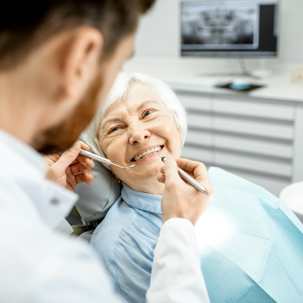 Older woman getting teeth examined